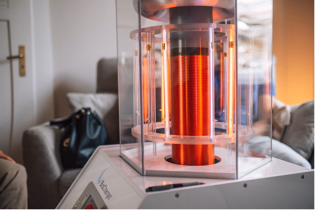 Biocharger-Geraet mit rot leuchtender Glasroehre in einem Wohnzimmer